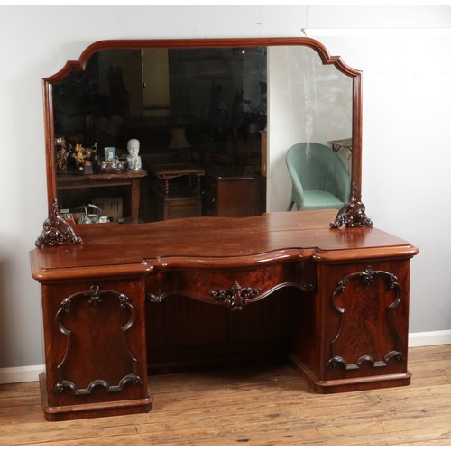 554 - A Victorian mahogany breakfront mirror back sideboard, with central pull out drawer flanked by two c... 