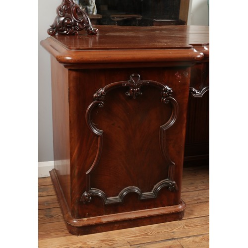 554 - A Victorian mahogany breakfront mirror back sideboard, with central pull out drawer flanked by two c... 