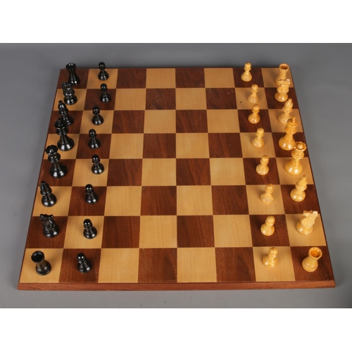 349 - A tabletop chess/checkers board along with a complete set of carved chess pieces.