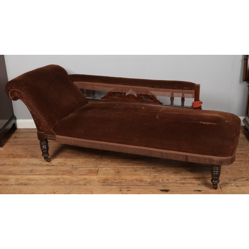 384 - A Victorian carved mahogany chaise lounge upholstered in brown velvet with fringe detail.

Hx73cm
Wx... 