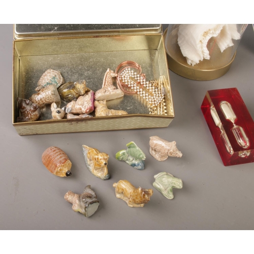 28 - A mixed collection of collectables featuring Wade whimsies, a white coral ornament displayed in a gl... 