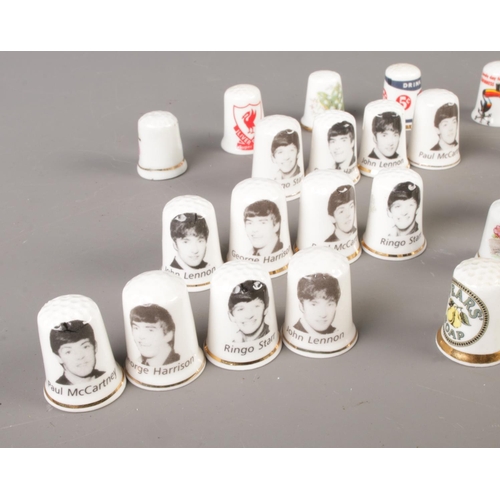 33 - A selection of various thimbles including three sets of Beatles thimbles