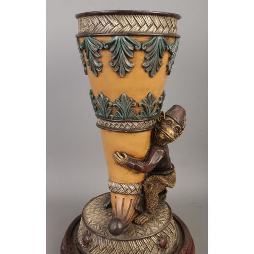 56 - A vintage composite monkey butler vase on wooden base, size H34 x W20cm including the base.