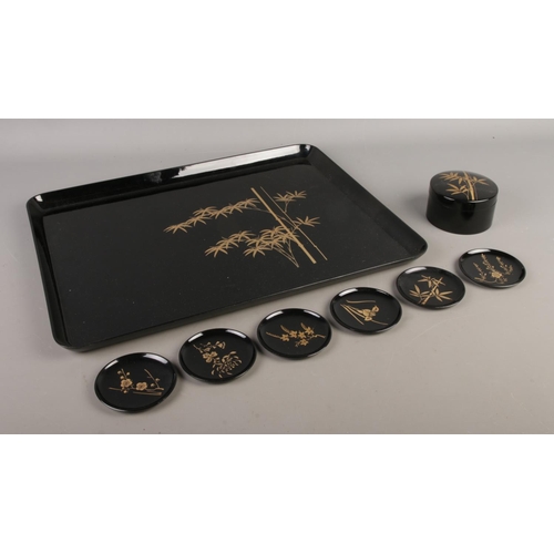 69 - A Japanese lacquered tray with gilt detailing depicting bamboo together with a trinket box of simila... 