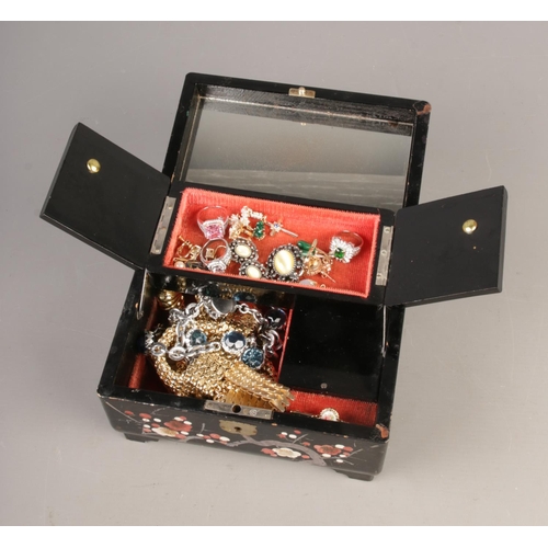 79 - A lacquered jewellery box containing vintage dress jewellery