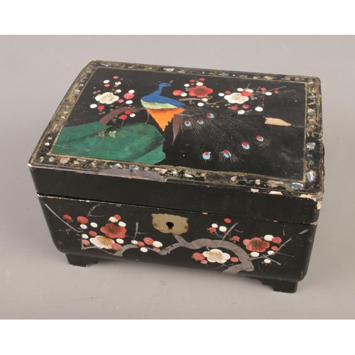 79 - A lacquered jewellery box containing vintage dress jewellery