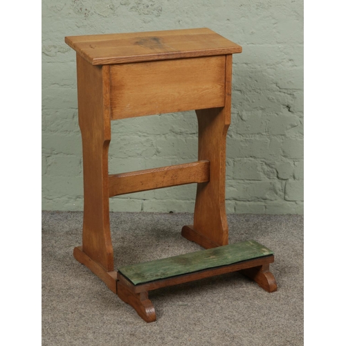 377 - An oak prayer stand with fold away kneeling pad.

Hx76cm