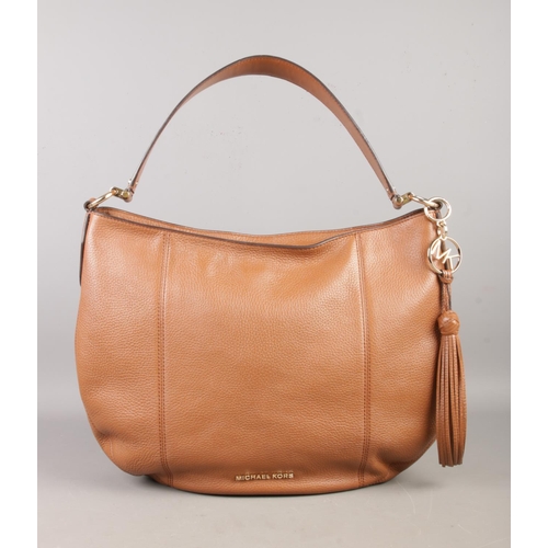 88 - A Michael Kors tan handbag, with strap and zipped top, gold coloured MK logo and links. Width: 37cm.