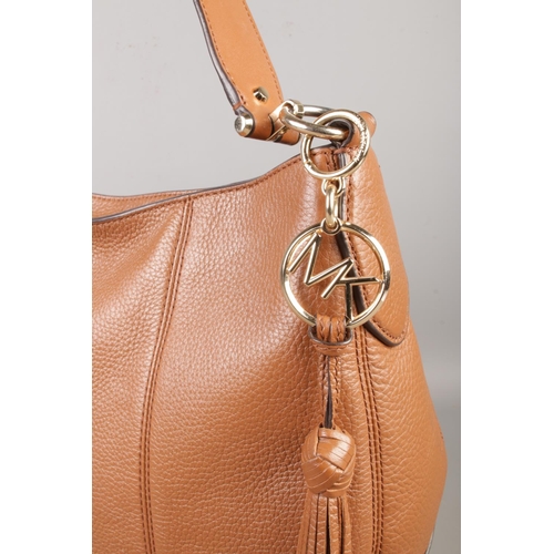 88 - A Michael Kors tan handbag, with strap and zipped top, gold coloured MK logo and links. Width: 37cm.