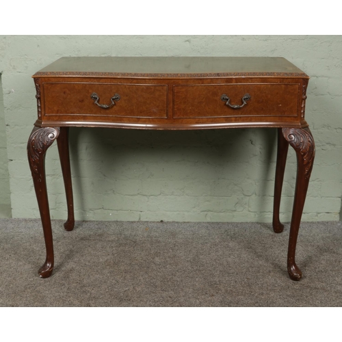 406 - A Queen Anne style walnut side table with carved edging and two drawers, raised on cabriole feet. He... 