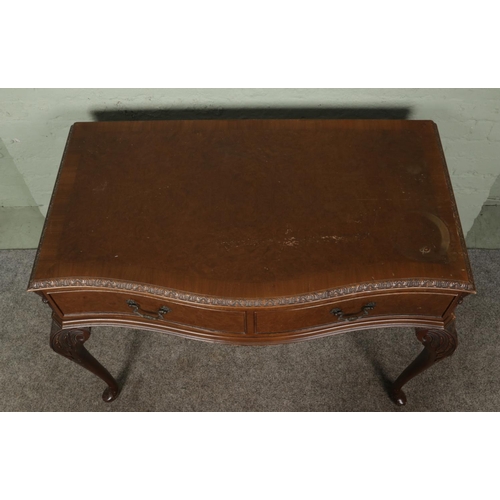 406 - A Queen Anne style walnut side table with carved edging and two drawers, raised on cabriole feet. He... 