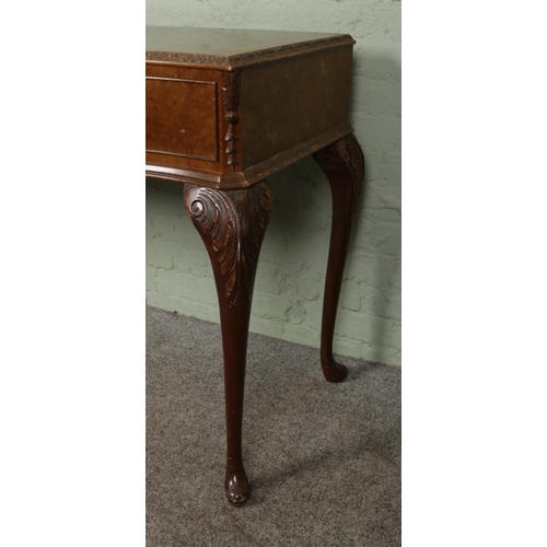 406 - A Queen Anne style walnut side table with carved edging and two drawers, raised on cabriole feet. He... 