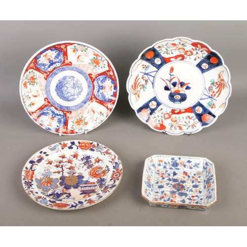 92 - Three antique Meiji Japanese porcelain plates and one square dish, hand-painted in a scalloped Imari... 