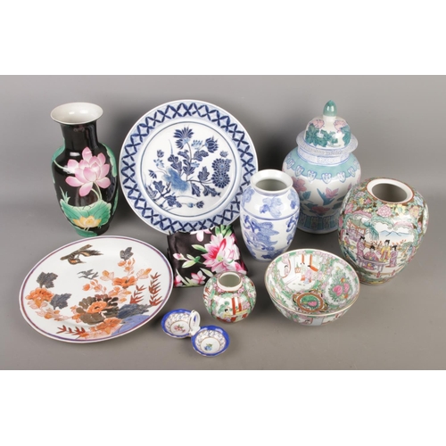 94 - A collection of Chinese ceramics, including three Canton famille rose vases and a bowl, alongside ot... 