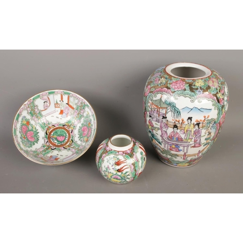 94 - A collection of Chinese ceramics, including three Canton famille rose vases and a bowl, alongside ot... 