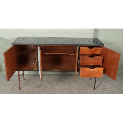 477 - A mid-century retro sideboard and matched rectangular table, with black marble effect surface and me... 