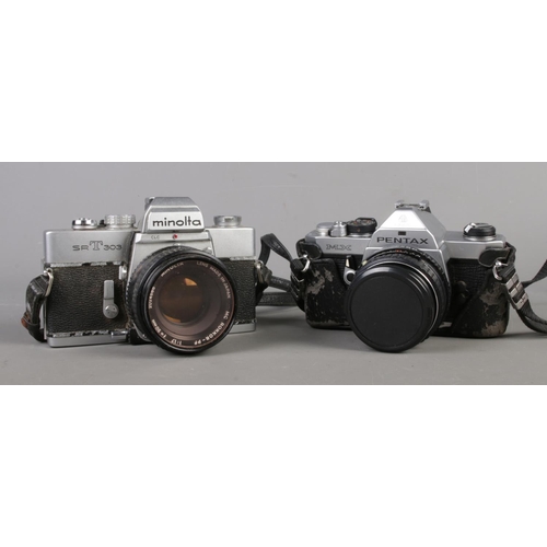 29 - Two vintage SLR cameras, one in fitted case, together with a quantity of accessories. Asahi Pentax M... 