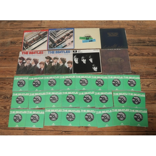 41 - A collection of The Beatles records and singles to include unboxed 1982 international release 'The B... 