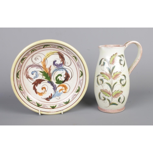 56 - Two pieces of Glyn College ceramics; a jug and washbowl plate, both decorated with leaves and swirls... 