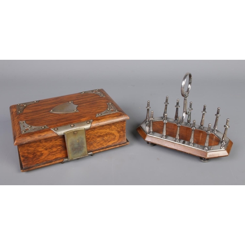 58 - A John Grisnell and Sons silver plate mounted toast rack along with white metal mounted cigar box fo... 