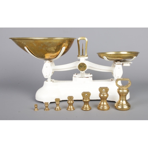 59 - A set of cast metal Libra kitchen scales, with a set of seven brass weights; ¼oz to 1lb.