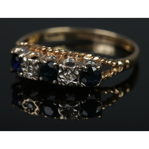 385 - A 9ct gold diamond and sapphire five stone ring. Size N½, 1.7g.