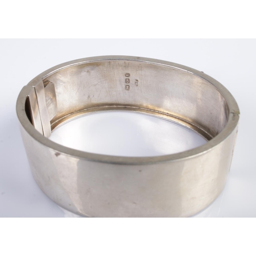 387 - A Victorian silver bangle formed as a decorative floral belt buckle. Hallmarked for Birmingham 1884,... 