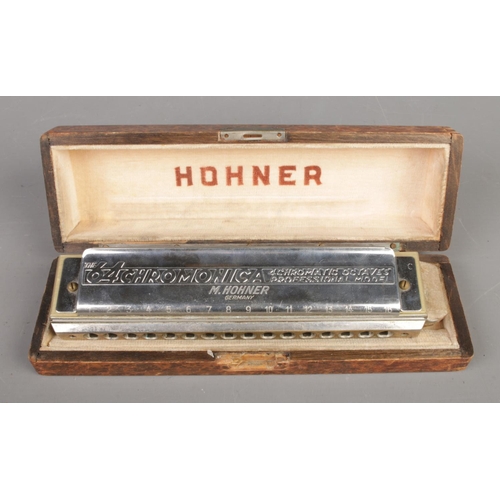 407 - A cased M. Hohner The 64 Chromonica professional model harmonica with 4 chromatic octaves.