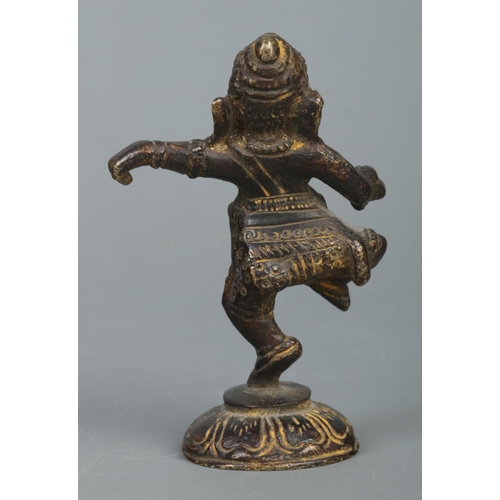 411 - A small bronze figure of the Hindu God Ganesha, raised on lotus flower base. Height: 9cm.