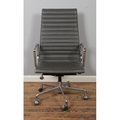 453 - After Charles & Ray Eames for Herman Miller, a polished chromed base swivel office armchair, raised ... 