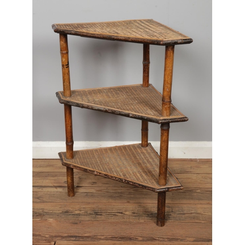 474 - A bamboo three tier corner shelving unit. Approx. dimensions 64cm x 40cm x 80cm.