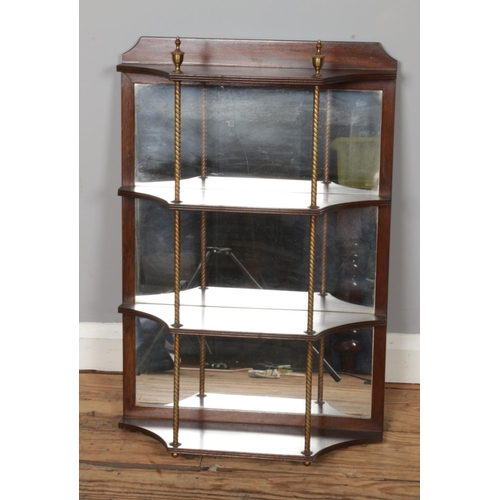 475 - A mahogany four tier wall mounted shelving unit featuring mirror back and gilt column supports. Appr... 