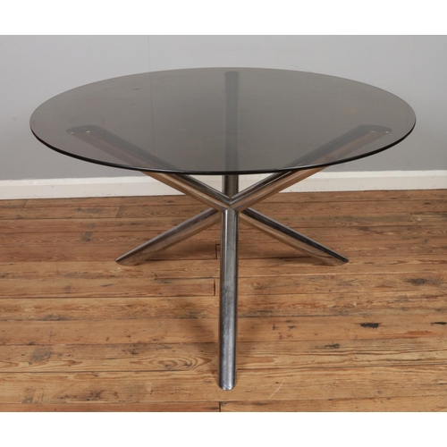 485 - Renato Zevi for Roche Bobois; a chromed tubular framed dining table with smoked glass top. Diameter:... 