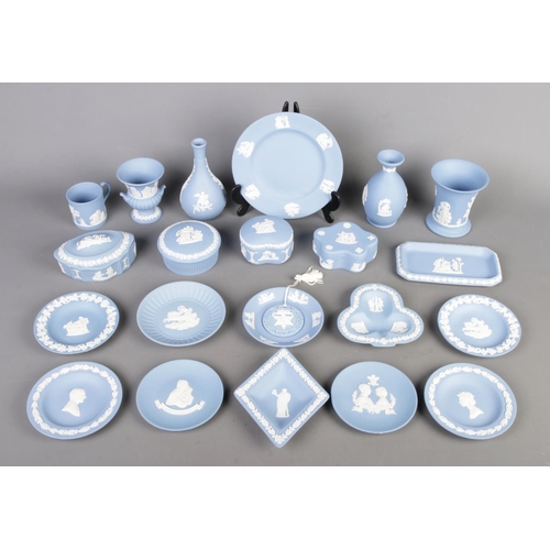 26 - Collection of blue Wedgwood Jasperware, including lidded boxes, vases, plates and cups, totalling tw... 