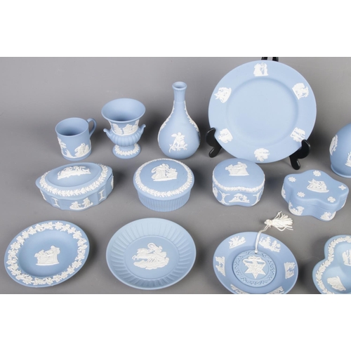 26 - Collection of blue Wedgwood Jasperware, including lidded boxes, vases, plates and cups, totalling tw... 