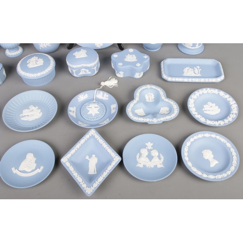 26 - Collection of blue Wedgwood Jasperware, including lidded boxes, vases, plates and cups, totalling tw... 