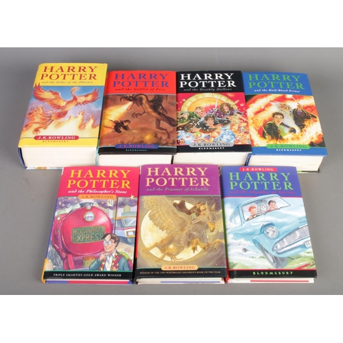 32 - J.K. Rowling's Harry Potter series, complete with seven hardcover books, all First Editions.