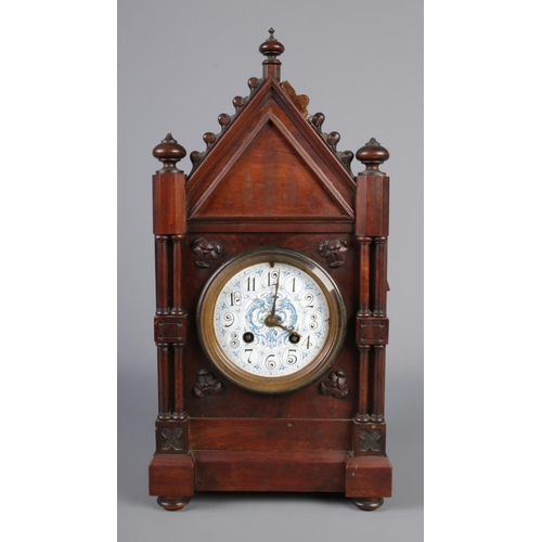 48 - A gothic revival mantel clock with mahogany body and ceramic hand painted blue and white dial and Ja... 