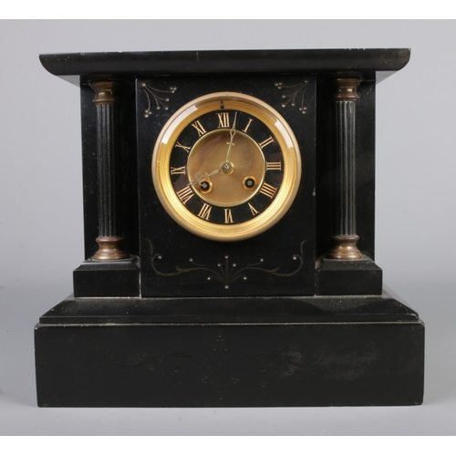 55 - A slate 8 day mantel clock with black and gilt dial.

29x31cm