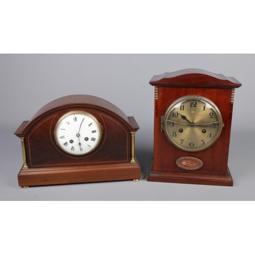 61 - Two mahogany mantel clocks one having satin wood inlay and brass columns.