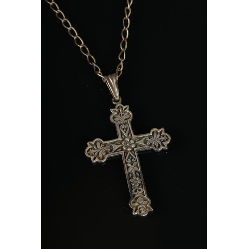 392 - A sterling silver cross on chain.