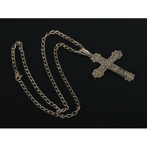 392 - A sterling silver cross on chain.