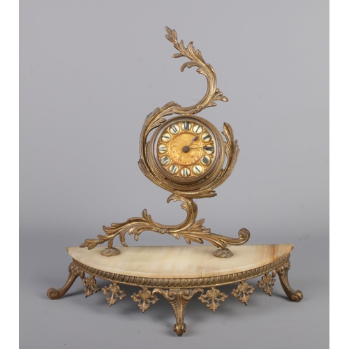 65 - A 19th century drum clock mounted in a gilt metal rococo style frame on onyx base and gilt metal sta... 