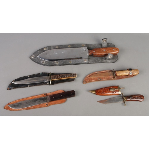 408 - A collection of five vintage knives, featuring assorted hunting knives and a large Japanese Hori Hor... 