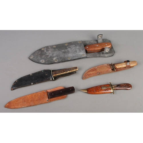 408 - A collection of five vintage knives, featuring assorted hunting knives and a large Japanese Hori Hor... 