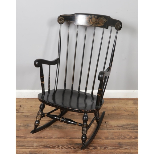 454 - A vintage black Boston rocker, with Windsor back and flower pattern on the headrest. Size W62 x D102... 