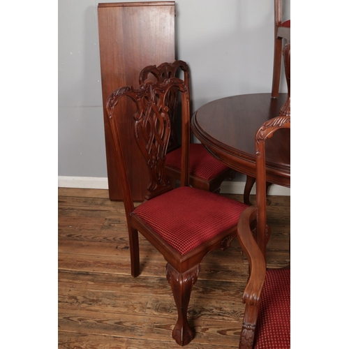 459 - A substantial mahogany ball and claw dining table with two additional leaves and set of ten chairs i... 