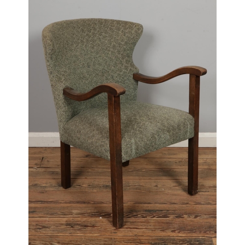 464 - An unusual mid century open armchair with wing back design, possibly of Danish origin.