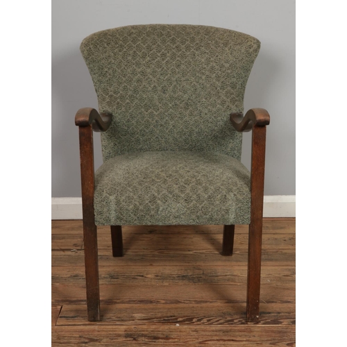 464 - An unusual mid century open armchair with wing back design, possibly of Danish origin.