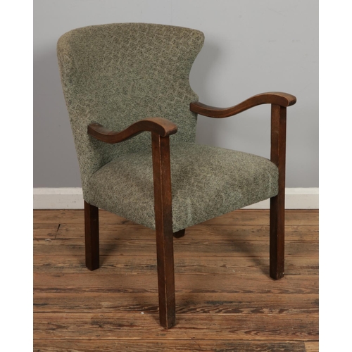 464 - An unusual mid century open armchair with wing back design, possibly of Danish origin.